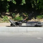 In Vilnius, a car hit a man riding a scooter across a pedestrian crossing