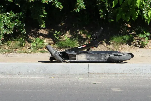In Vilnius, a car hit a man riding a scooter across a pedestrian crossing