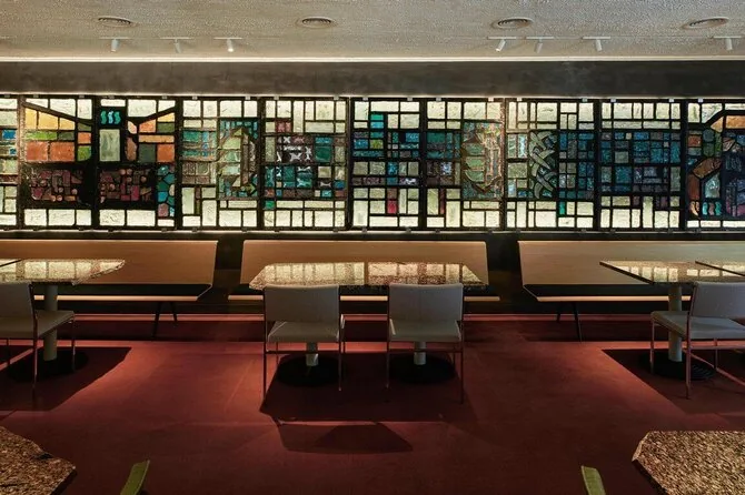 Darius Petrulaitis photo/The interior of the restaurant and sauna club uses restored furniture and preserved stained glass from a demolished building in Klaipėda. Arch. Mantas Peteraitis, stained glass – Marija Anortė Mackelaitė