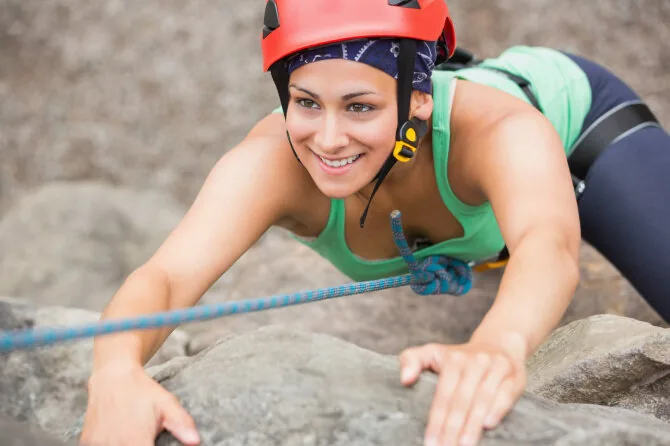 Shutterstock photo/Girl climbing a mountain.