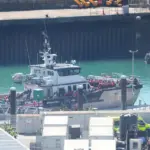 A boat with 128 migrants has reached England, media reports