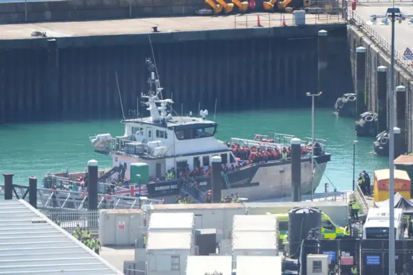 A boat with 128 migrants has reached England, media reports