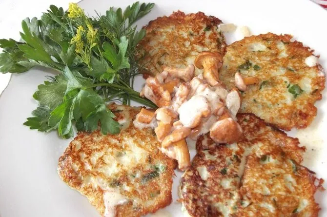 Fresh potato pancakes with herbs and chanterelles
