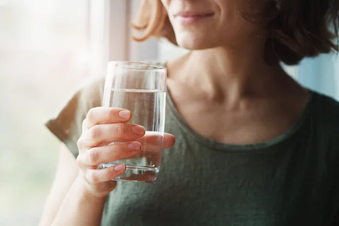 Shutterstock photo/Woman drinking water.