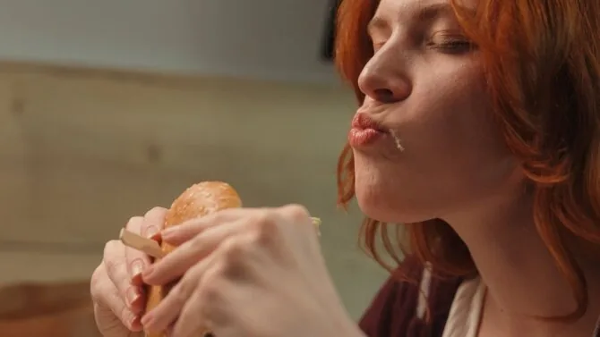 Shutterstock photo/Woman eating a hamburger