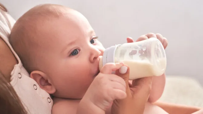 Shutterstock photo/Baby drinking formula