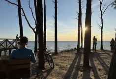People watch the solar eclipse at the seaside.