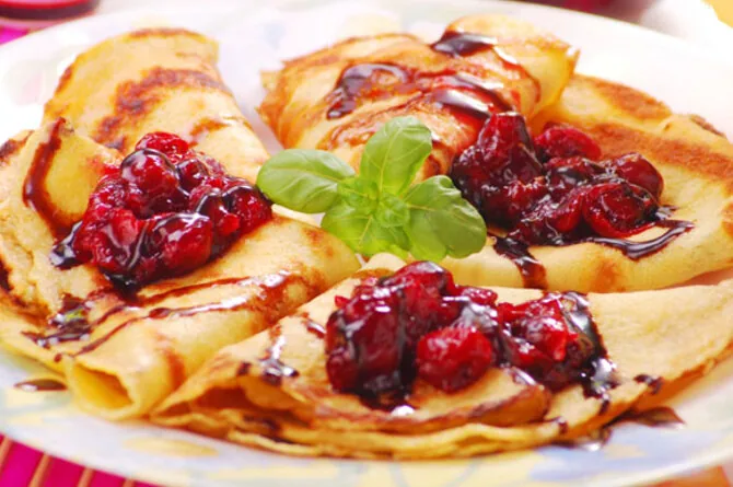 Crepes with curd cheese and mashed berries