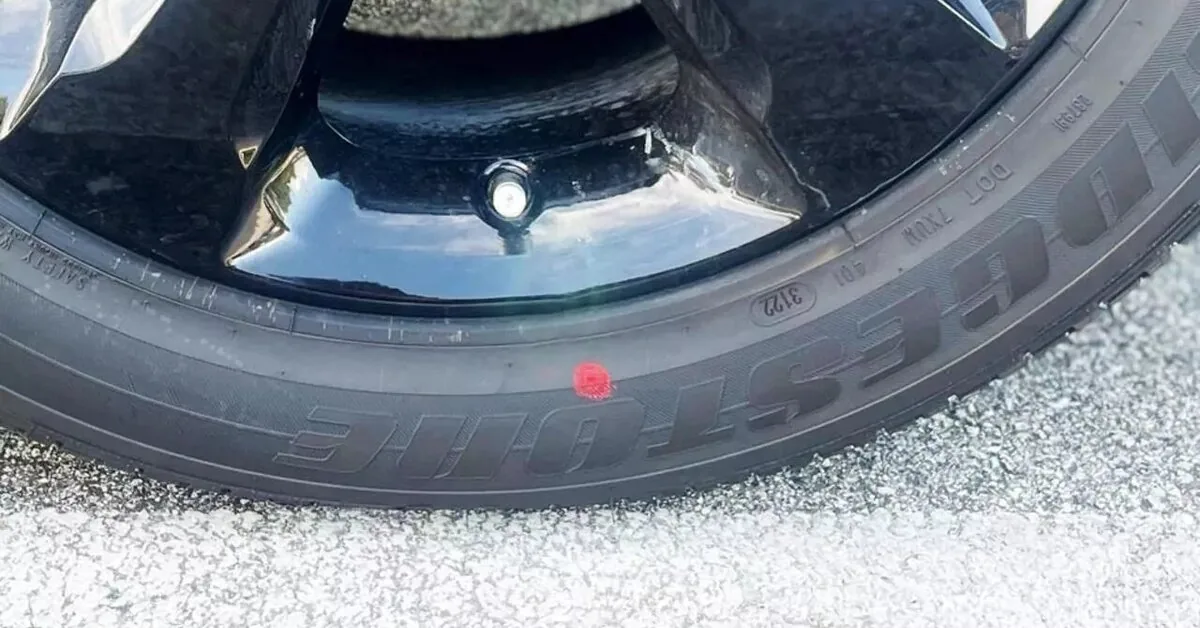 What does the red dot on your car tire mean?