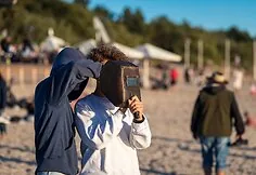 People watch the solar eclipse at the seaside