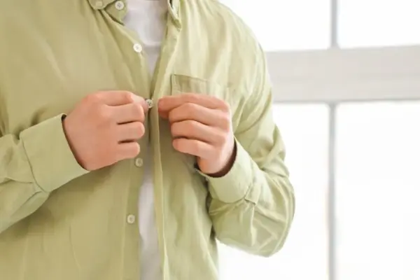 Why are buttons on men's and women's clothes on different sides?
