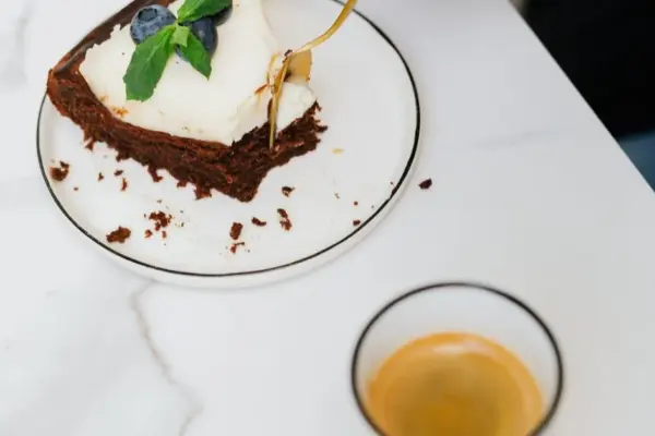 Perfect dessert: moist brownie with a fluffy curd layer and blueberries