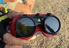 People watch the solar eclipse at the seaside.