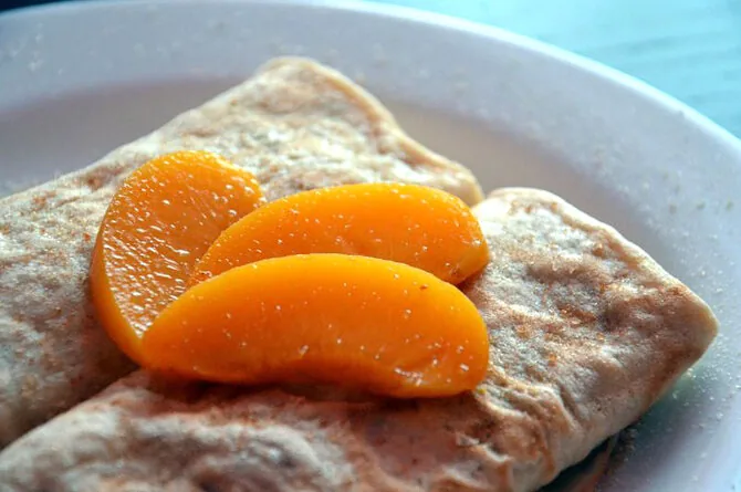Crepes with curd cheese and peaches