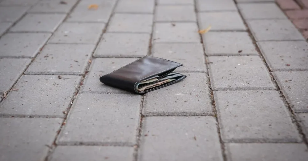 Officers are investigating who the wallet found by the woman belongs to