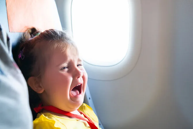 Shutterstock photo / Crying child on the plane