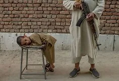 Guard at the entrance to the madrasa in Kabul